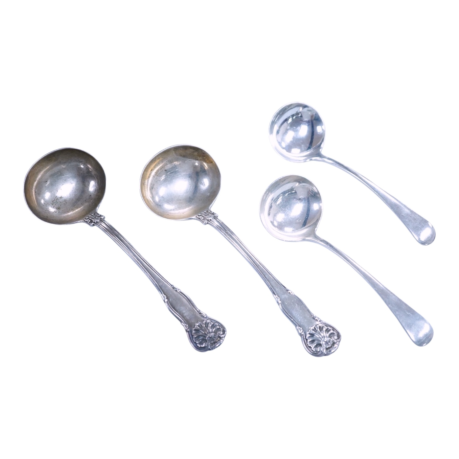 A pair of George IV silver King's husk pattern sauce ladles, by William Chawner II, London, 1825/27, 18.2cm, together with a pair of George VI Old English pattern sauce ladles, James Dixon & Sons, Sheffield, 1936, 7.9oz.